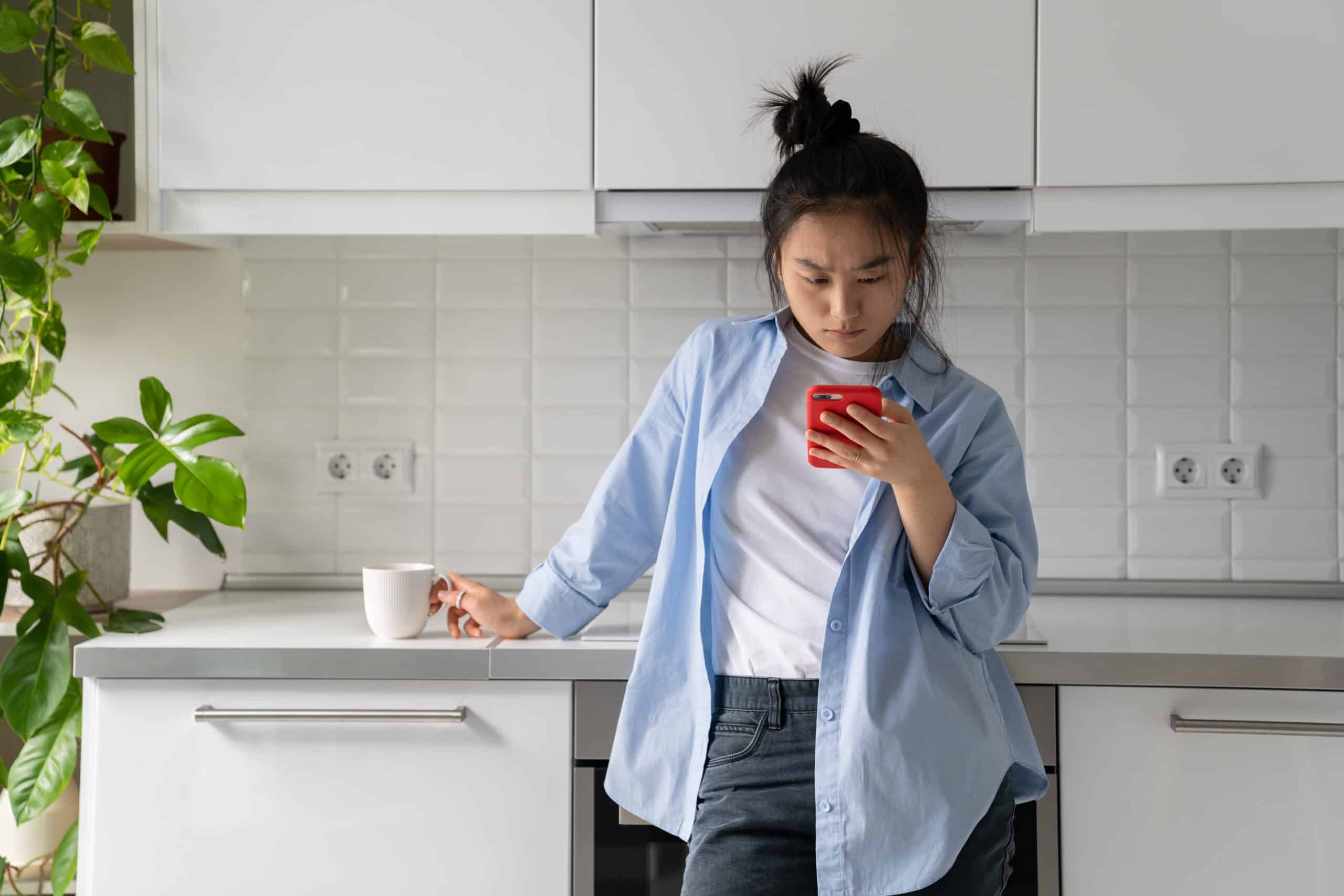 worried individual looking at news on phone