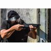 A man aiming at a target with an HDS 68 paintball shotgun.